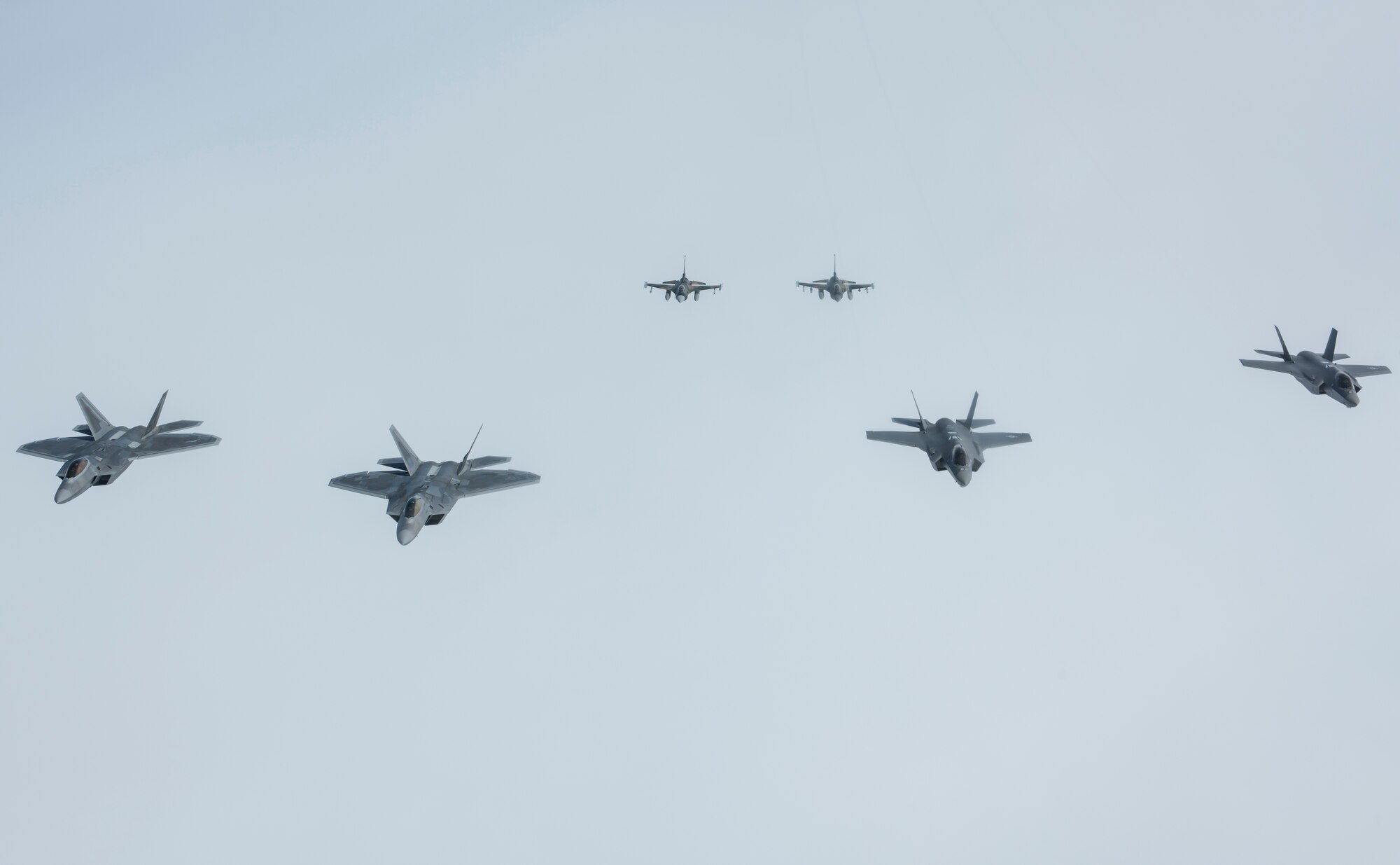 A formation of U.S. Air Force fighter aircraft stationed across Alaska fly in formation, representing the addition of the F-35A Lightning II to the fighter arsenal in Alaska, April 21, 2020.