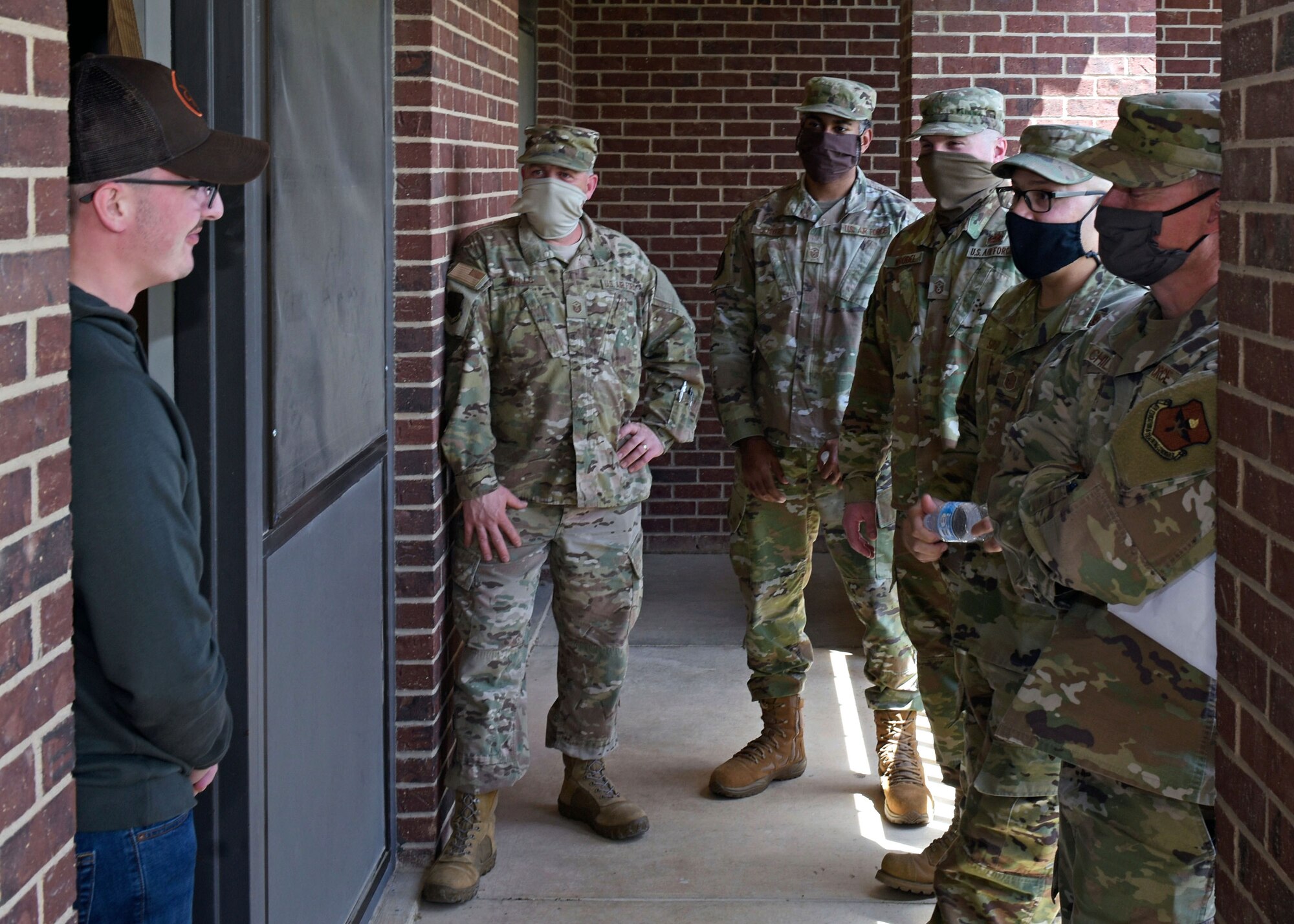U.S. Air Force First Sergeants check on permanent party Airmen at their dorms April 15, 2020, on Goodfellow Air Force Base, Texas. Since social distancing is imperative to stopping the spread of COVID-19, they are sure to take extra precautions when it comes to mental health and wellness checks on their Airmen. (U.S. Air Force photo by Senior Airman Zachary Chapman)