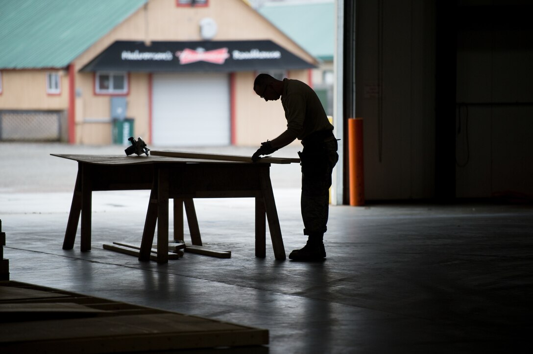 A Vermont National Guardsman works to construct a 400-bed medical surge facility at the Champlain Valley Exposition.