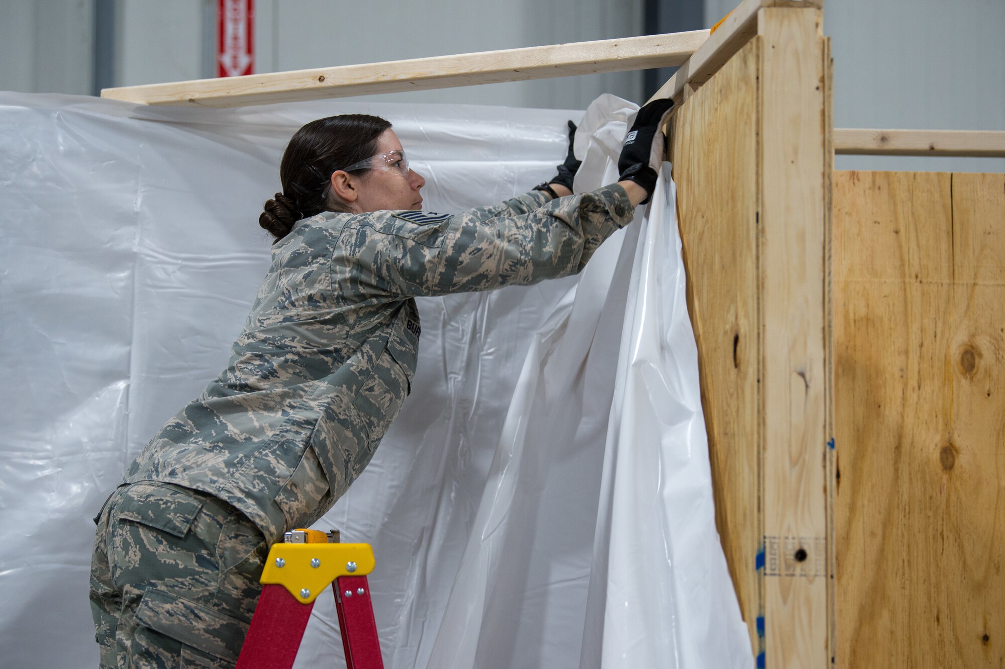 An Airman assigned to the 158th Fighter Wing, Vermont Air National Guard, works to construct a 400-bed medical health facility at the Champlain Valley Exposition