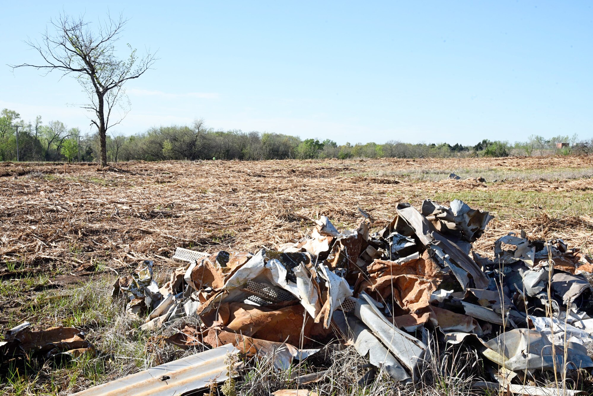 Piles of metal debris accumulated in a cedar-filled area on Tinker's southeast perimeter from the May 8, 2003 tornado. The 72nd Civil Engineering Directorate Natural Resources department hired a contractor to masticate the 40-acre area and another contractor to manually pick up the heavy debris that was found throughout the area and even in the trees.