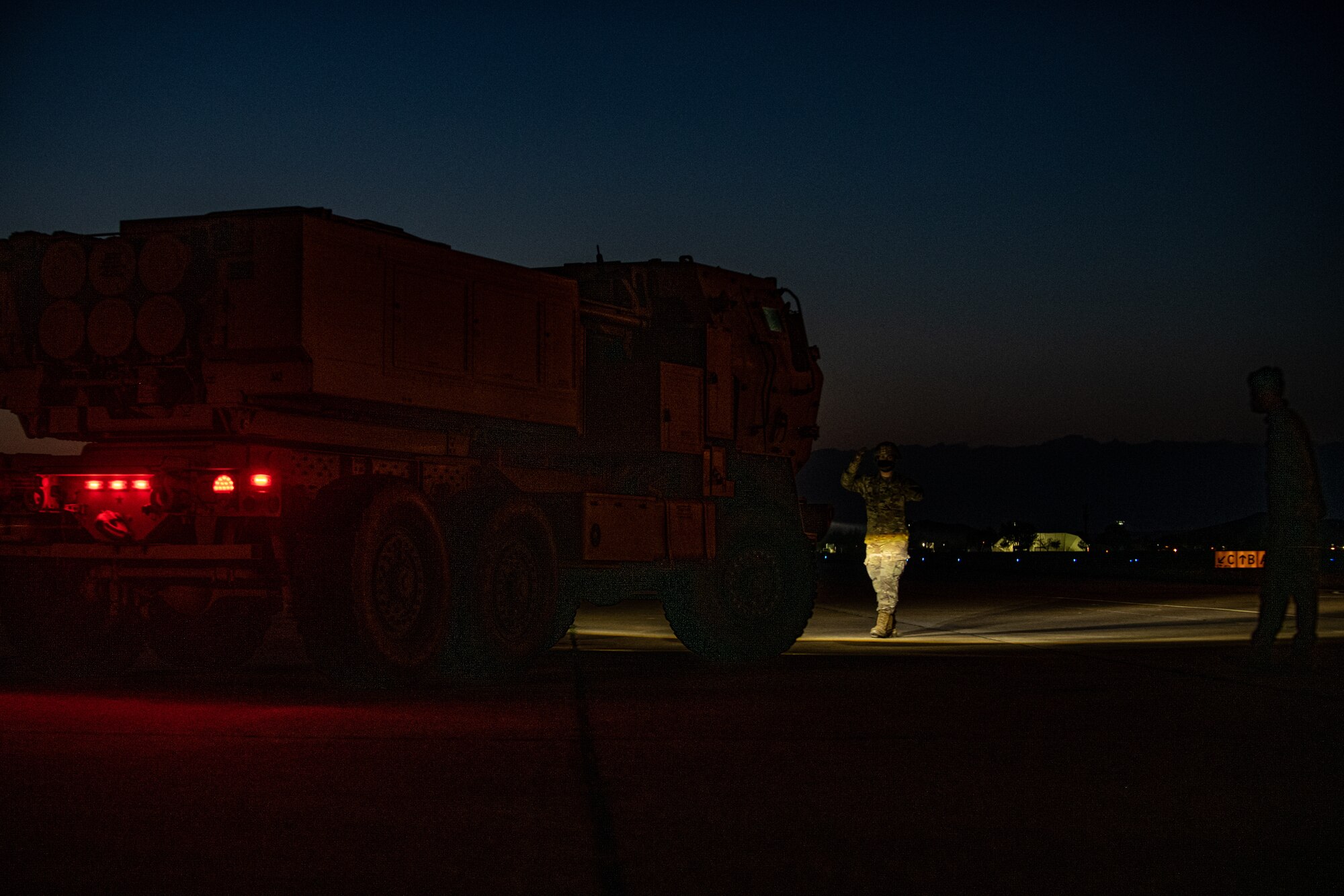 Airmen and Soldiers load cargo on a C-130J