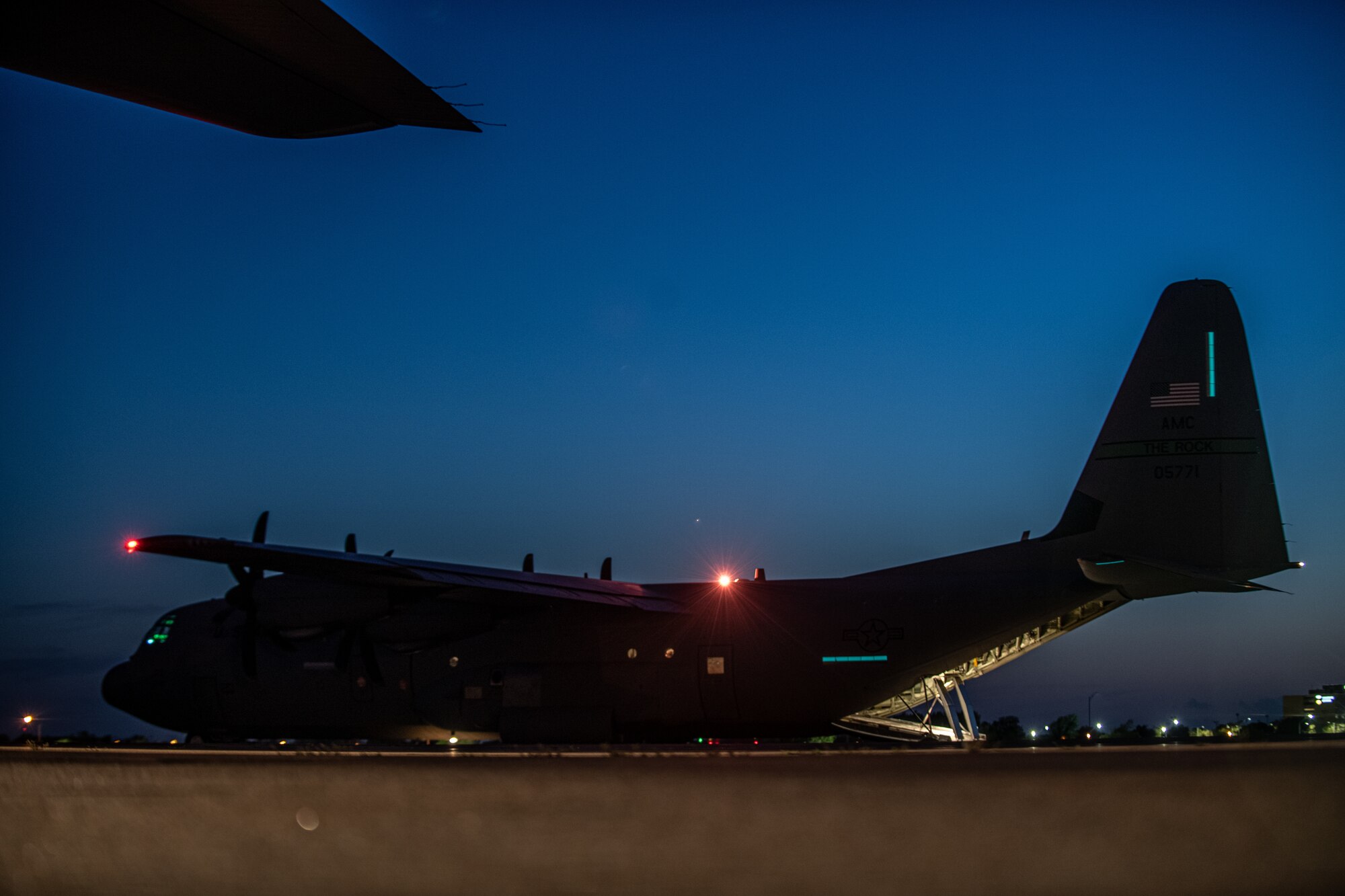 Airmen and Soldiers load cargo on a C-130J