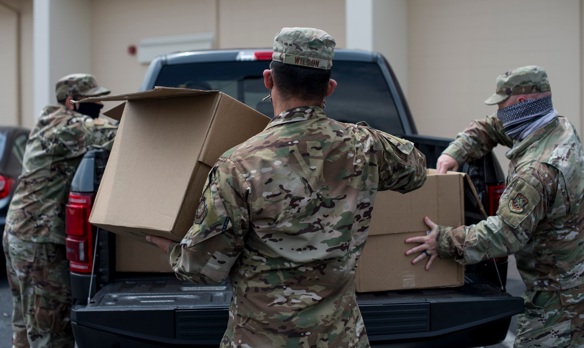 First sergeants from around the 6th Air Refueling Wing load care packages into a truck outside the Military and Family Readiness Center (MFRC) at MacDill Air Force Base, Fla., April 17, 2020.