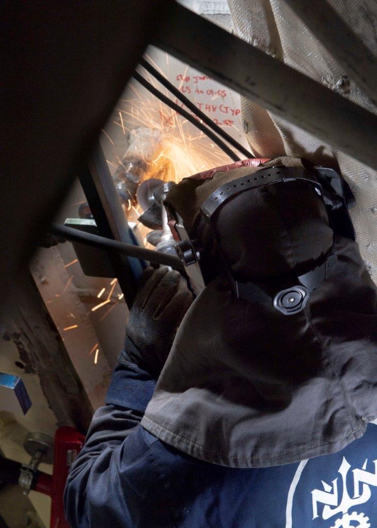 Eric Knight, an engineer with Huntington Ingalls Industries-Newport News Shipbuilding Division grinds on advanced lower stage weapons elevator aboard the aircraft carrier USS Gerald R. Ford (CVN 78), April 1, 2020. Gerald R. Ford is underway in the Atlantic Ocean conducting carrier qualifications.