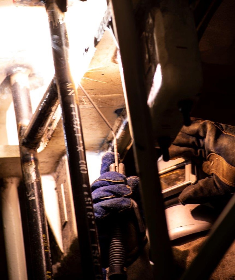 An engineer with Huntington Ingalls Industries-Newport News Shipbuilding Division welds on advanced lower stage weapons elevator aboard the aircraft carrier USS Gerald R. Ford (CVN 78), March 27, 2020. Gerald R. Ford is underway in the Atlantic Ocean conducting carrier qualifications.