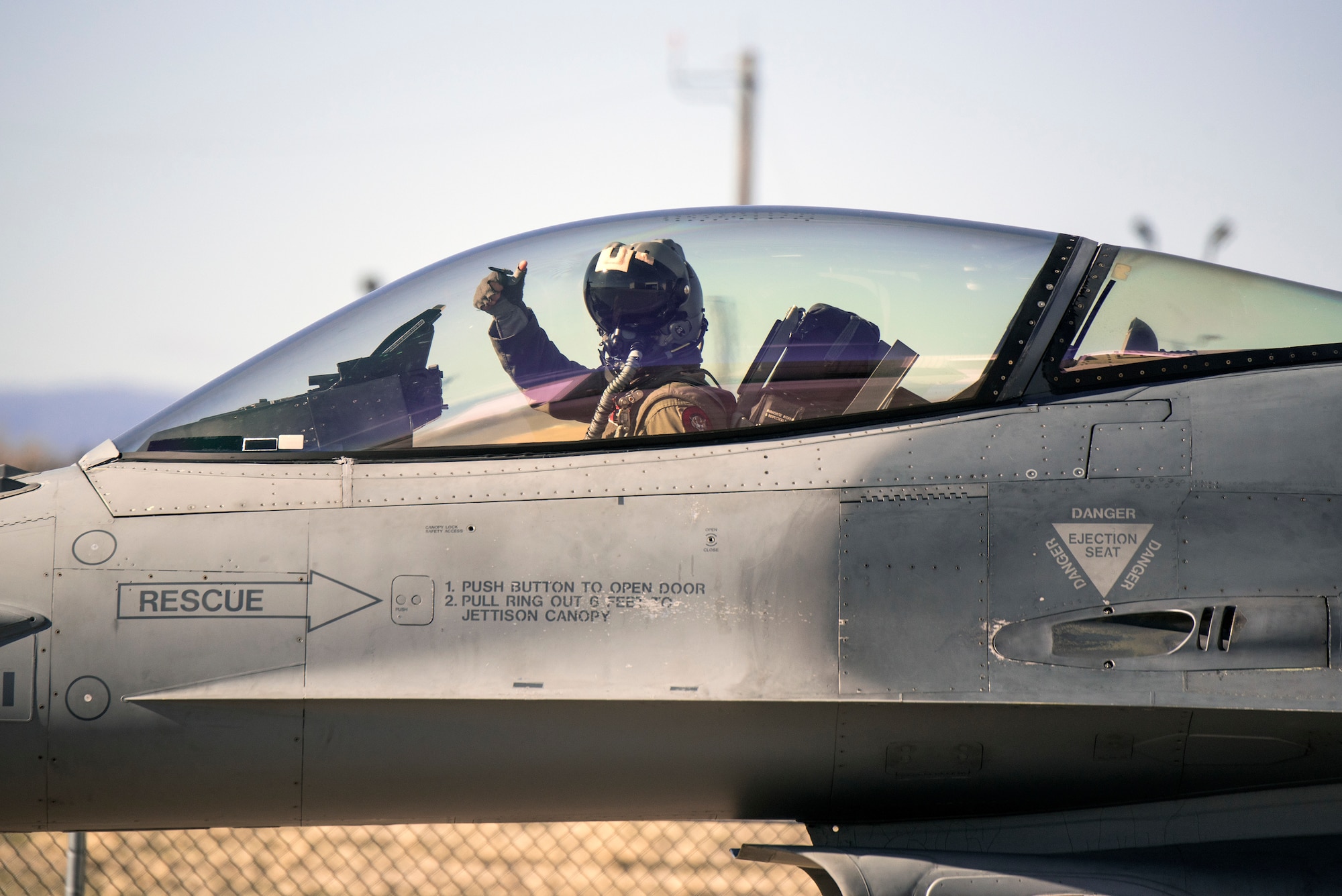 Pilot gives thumbs up in cockpit