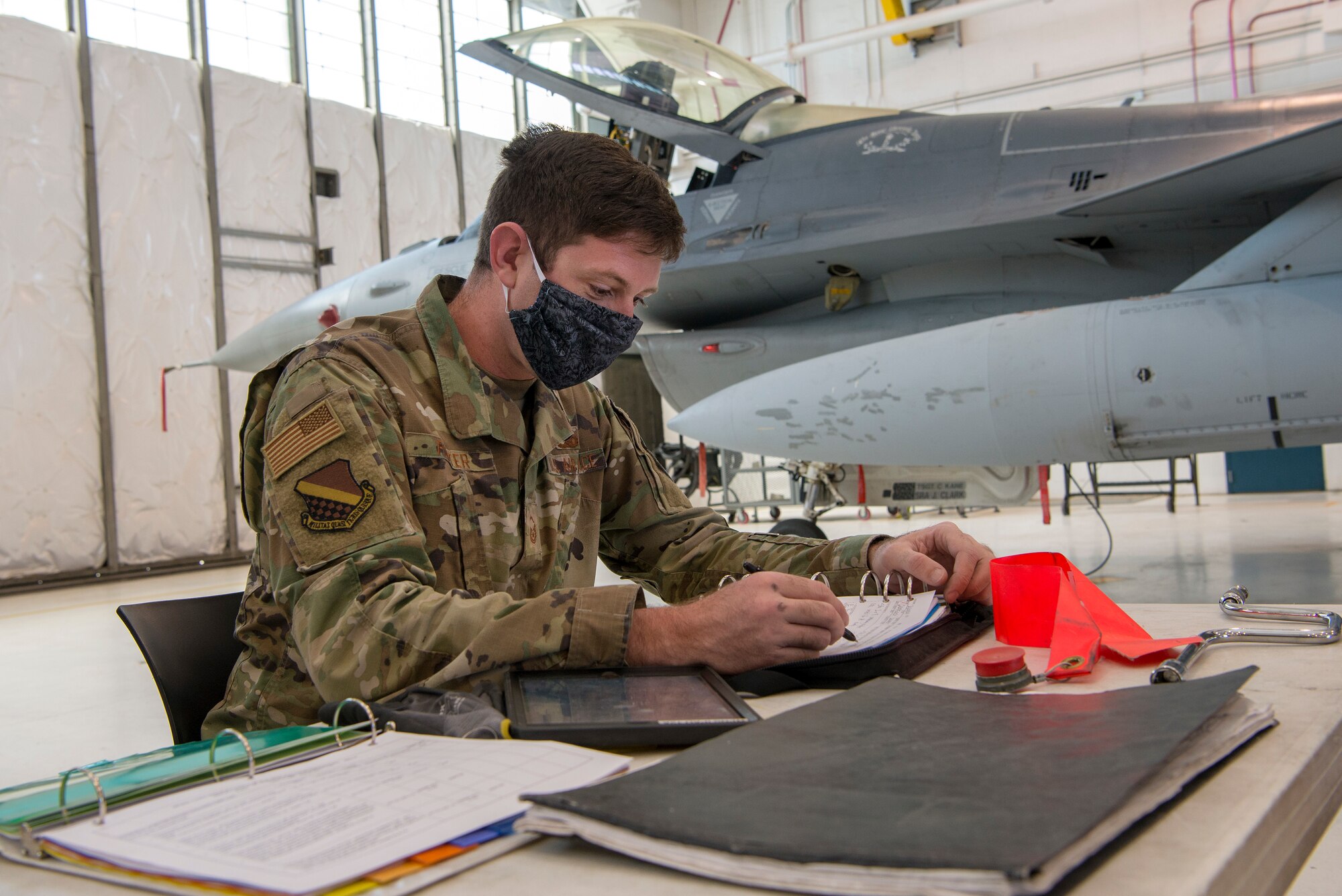 Maintenance airman working with mask on