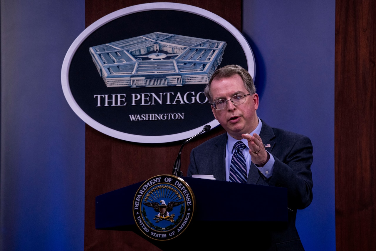 Man speaks from a lectern.