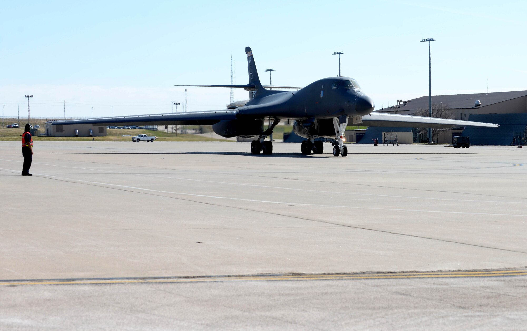 A U.S. Air Force B-1B Lancer is marshaled to the taxiway at Ellsworth Air Force Base, S.D., April 21, 2020. The B-1B’s speed and superior handling characteristics allow it to seamlessly integrate in mixed force packages. (U.S. Air Force photo by Airman Quentin K. Marx)