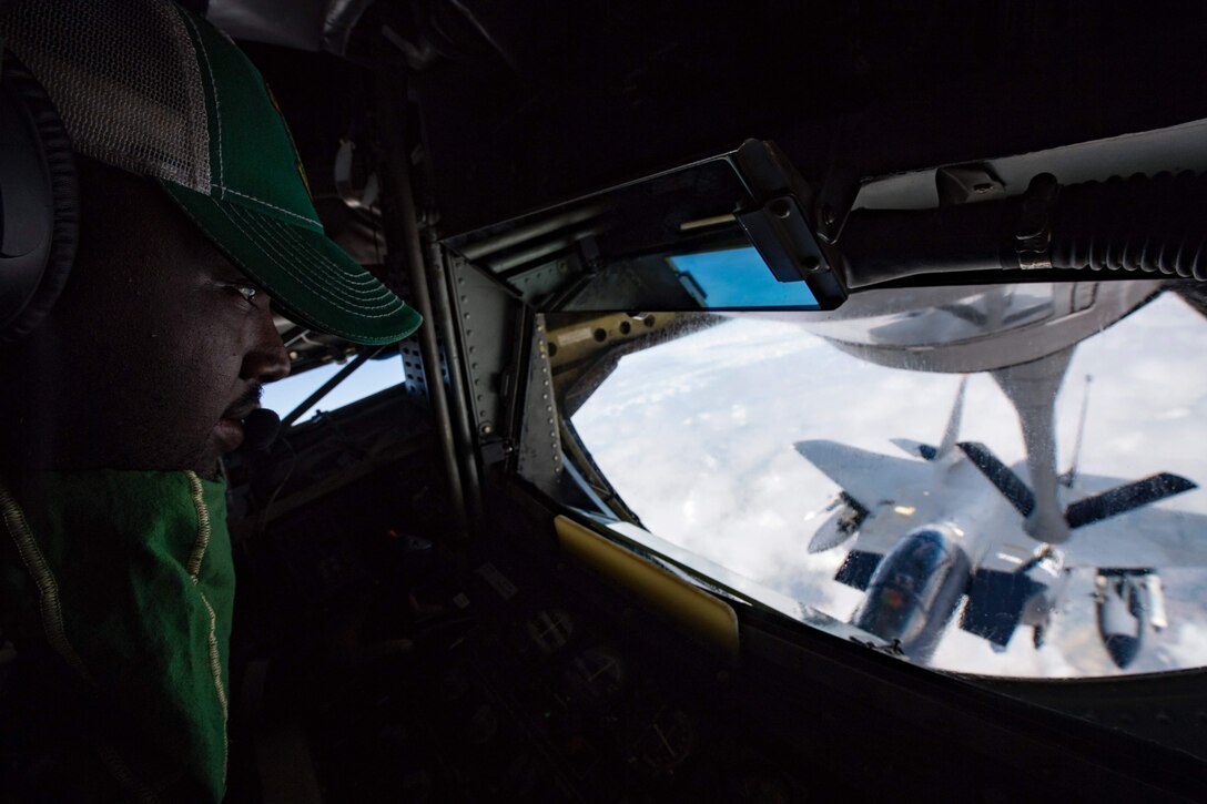 77 ARS boom operator in a refueling a jet from the boom pod of a KC-135 Stratotanker.