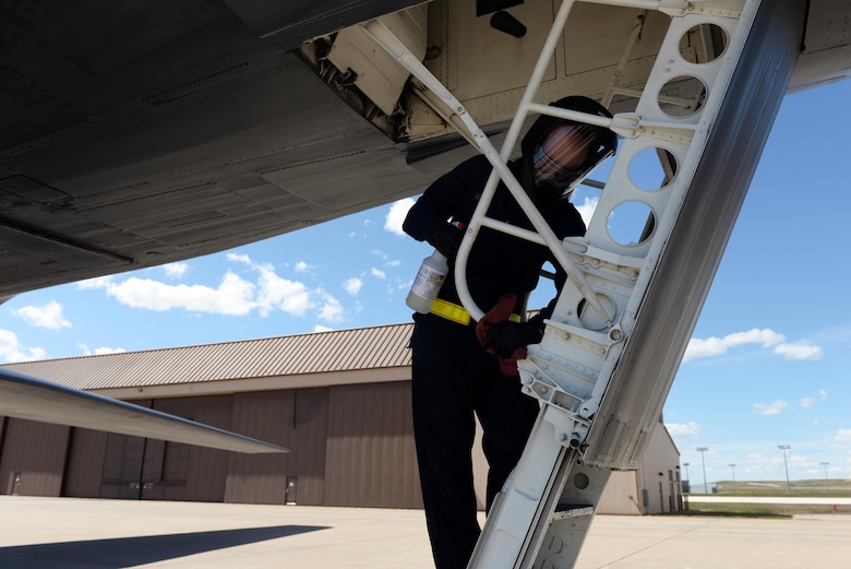 A maintainer assigned to the 28th Aircraft Maintenance Squadron wipes down the ladder of a B-1B Lancer at Ellsworth Air Force Base, S.D., April 22, 2020.