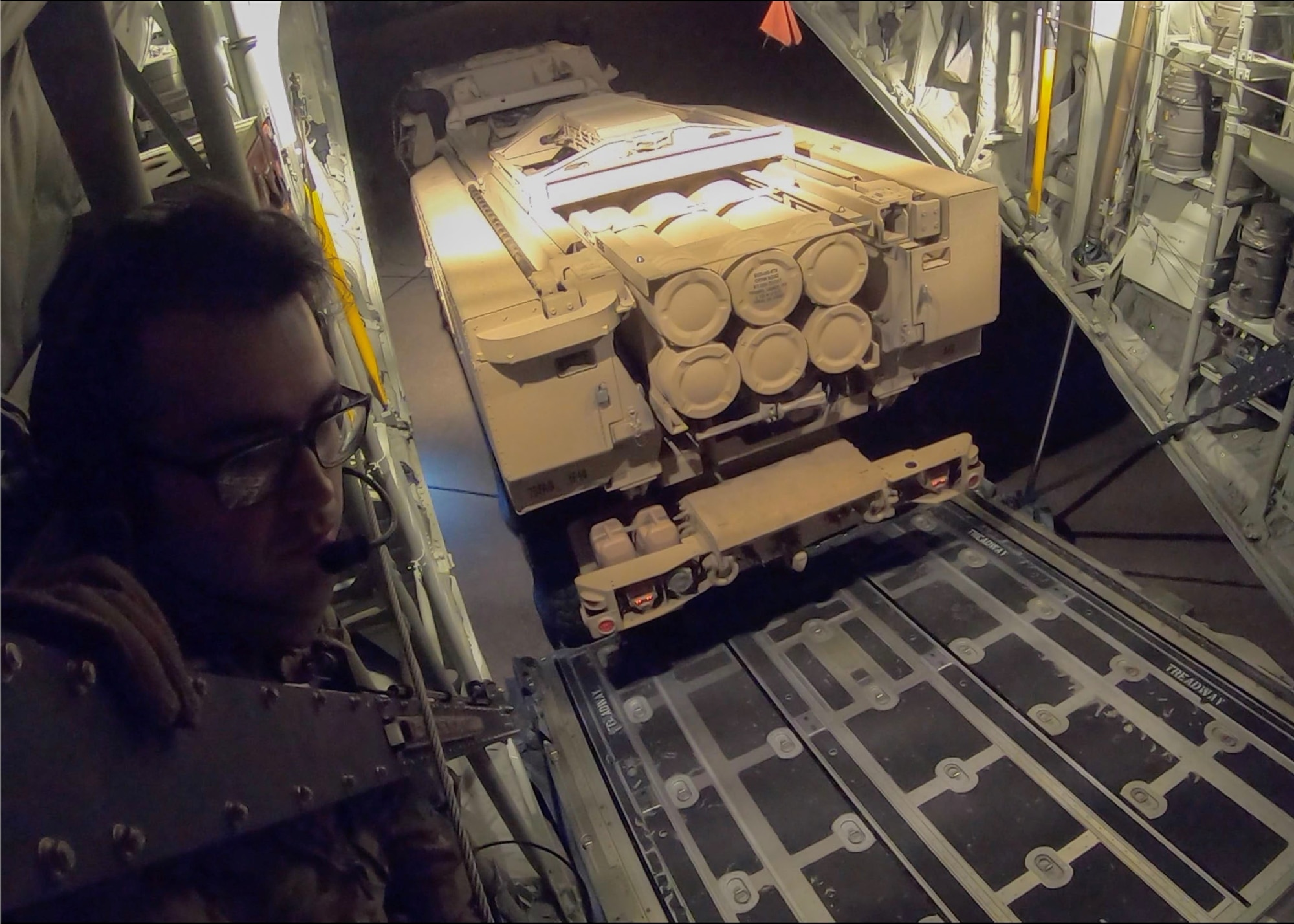 Airmen and Soldiers load cargo on a C-130J