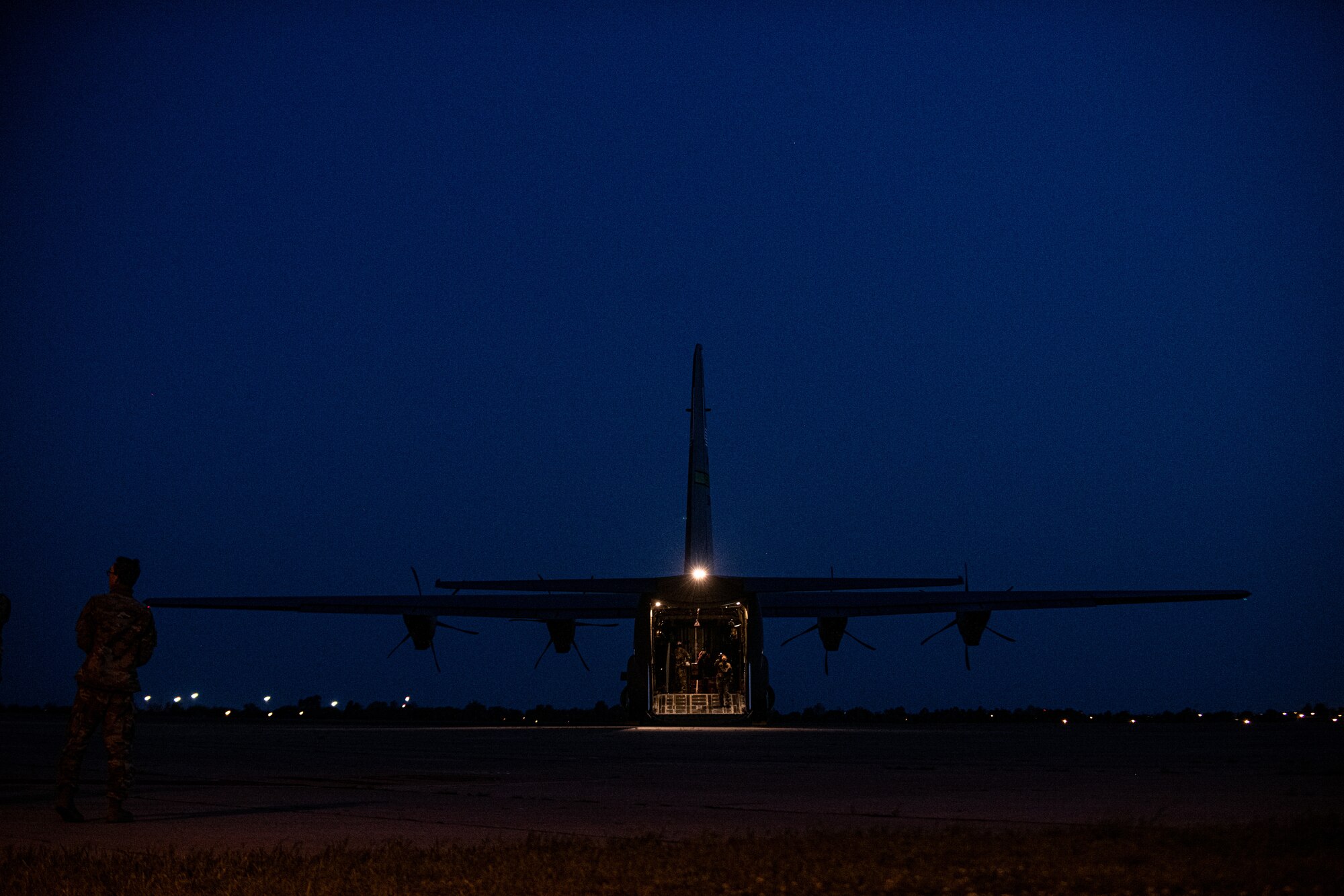 Airmen and Soldiers load cargo on a C-130J