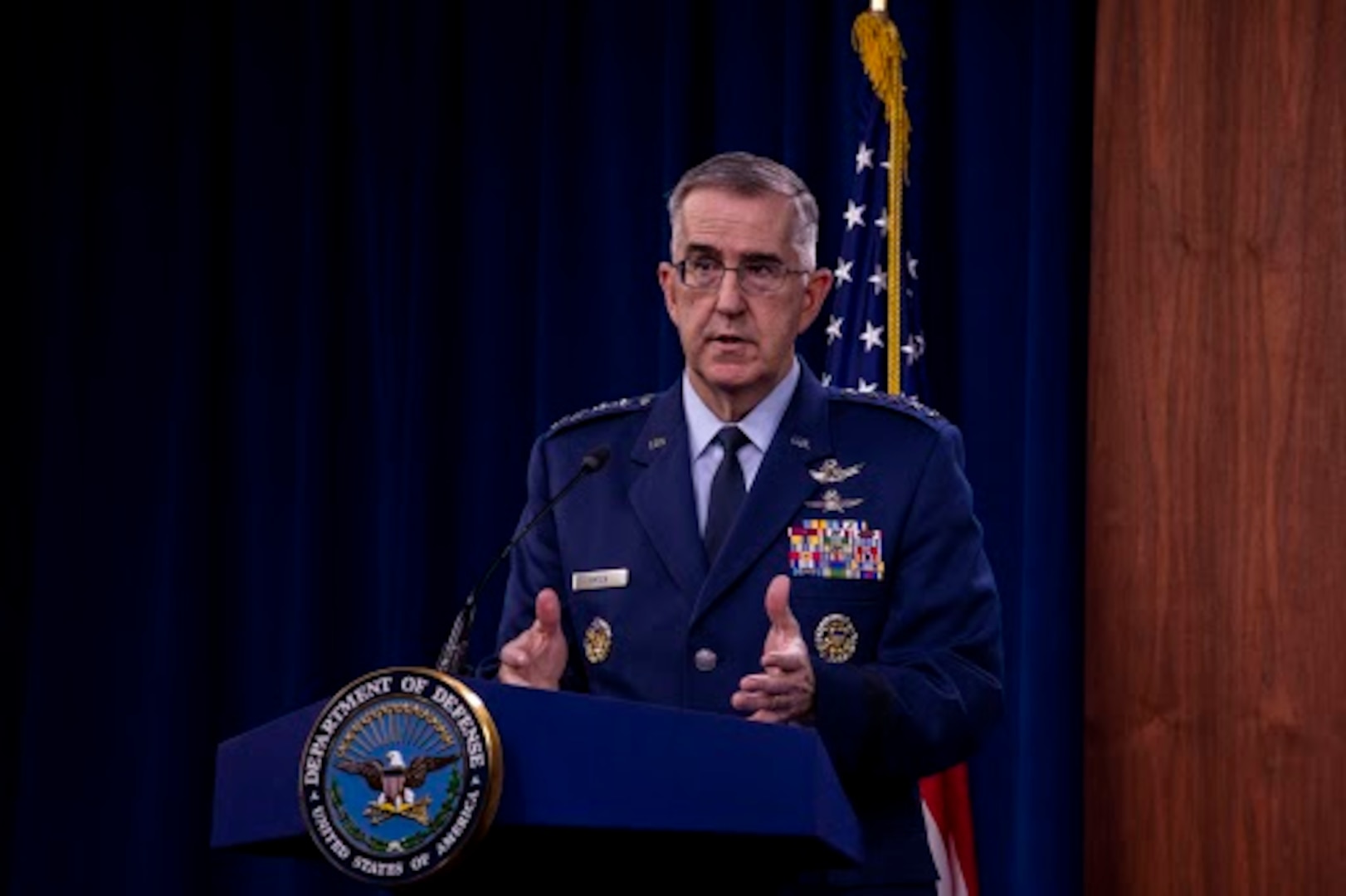 Air Force officer stands at lectern.