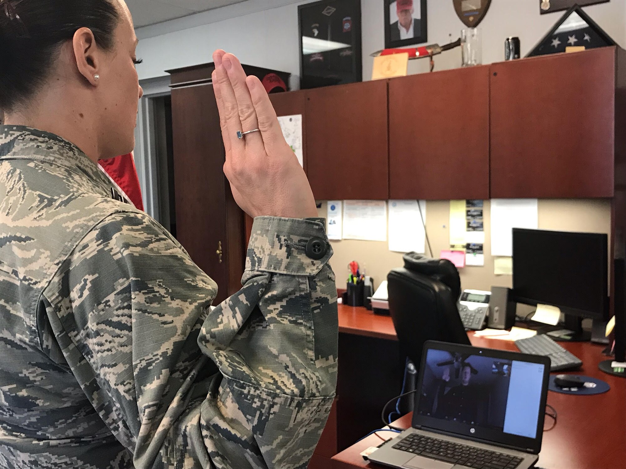 Capt. Vallaree McArthur conducts a virtual enlistment ceremony for Brendan Frazer, who recently signed up to serve as a Cyber Warfare Journeyman