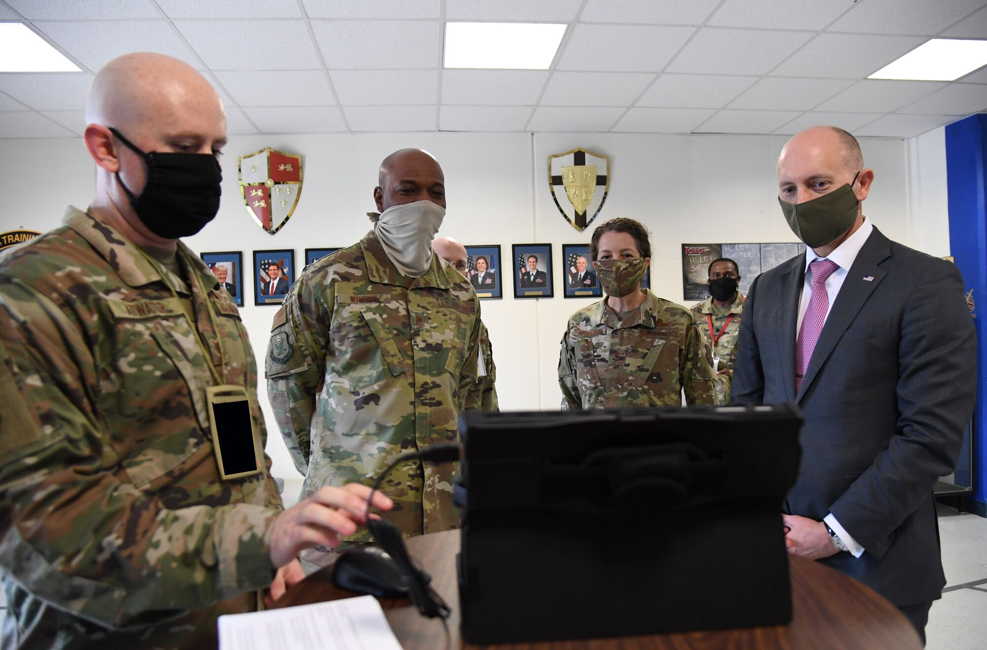 Airman briefs visitors with a laptop