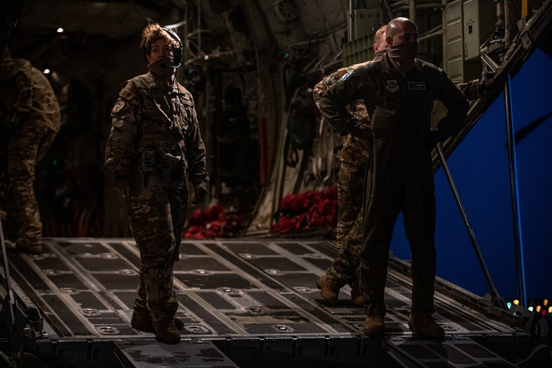 Airmen and Soldiers load cargo on a C-130J