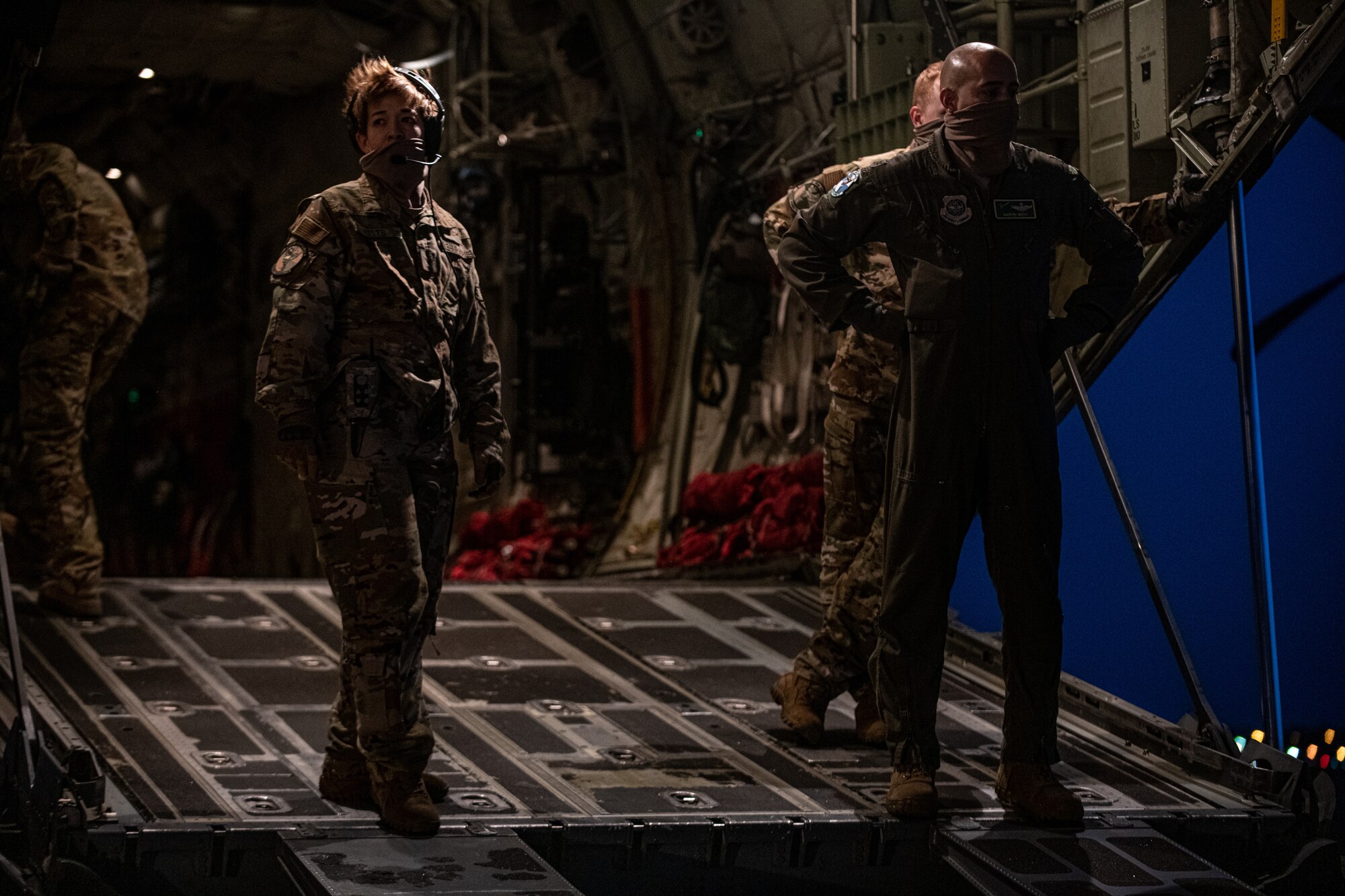 Airmen and Soldiers load cargo on a C-130J