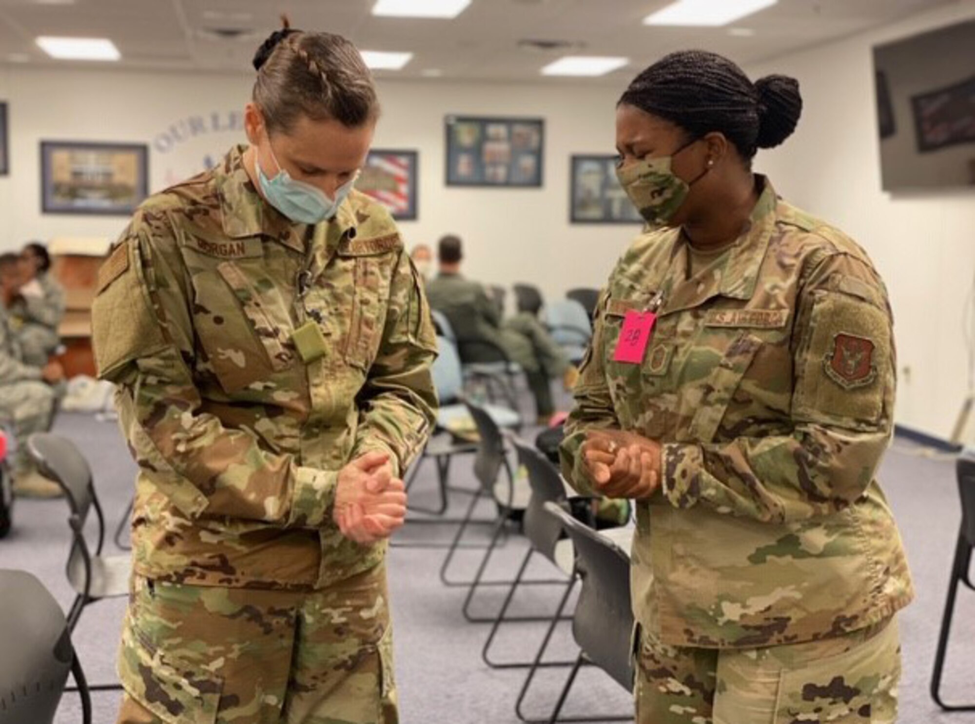 Lt. Col. Kimberly Morgan, 301st Medical Squadron aerospace family nurse practitioner, and Senior Master Sgt. Jonique Young, 301st Fighter Wing Religious Affairs superintendent, take a moment on April 22, 2020, before the former deploys in support of COVID-19 relief efforts from U.S. Naval Air Station Joint Reserve Base, Fort Worth, Texas. This deployment is part of a larger mobilization package of more than 770 Air Force Reservists from across the nation who are taking care of Americans fighting COVID-19. (U.S. Air Force photo by Capt. Jessica Gross)