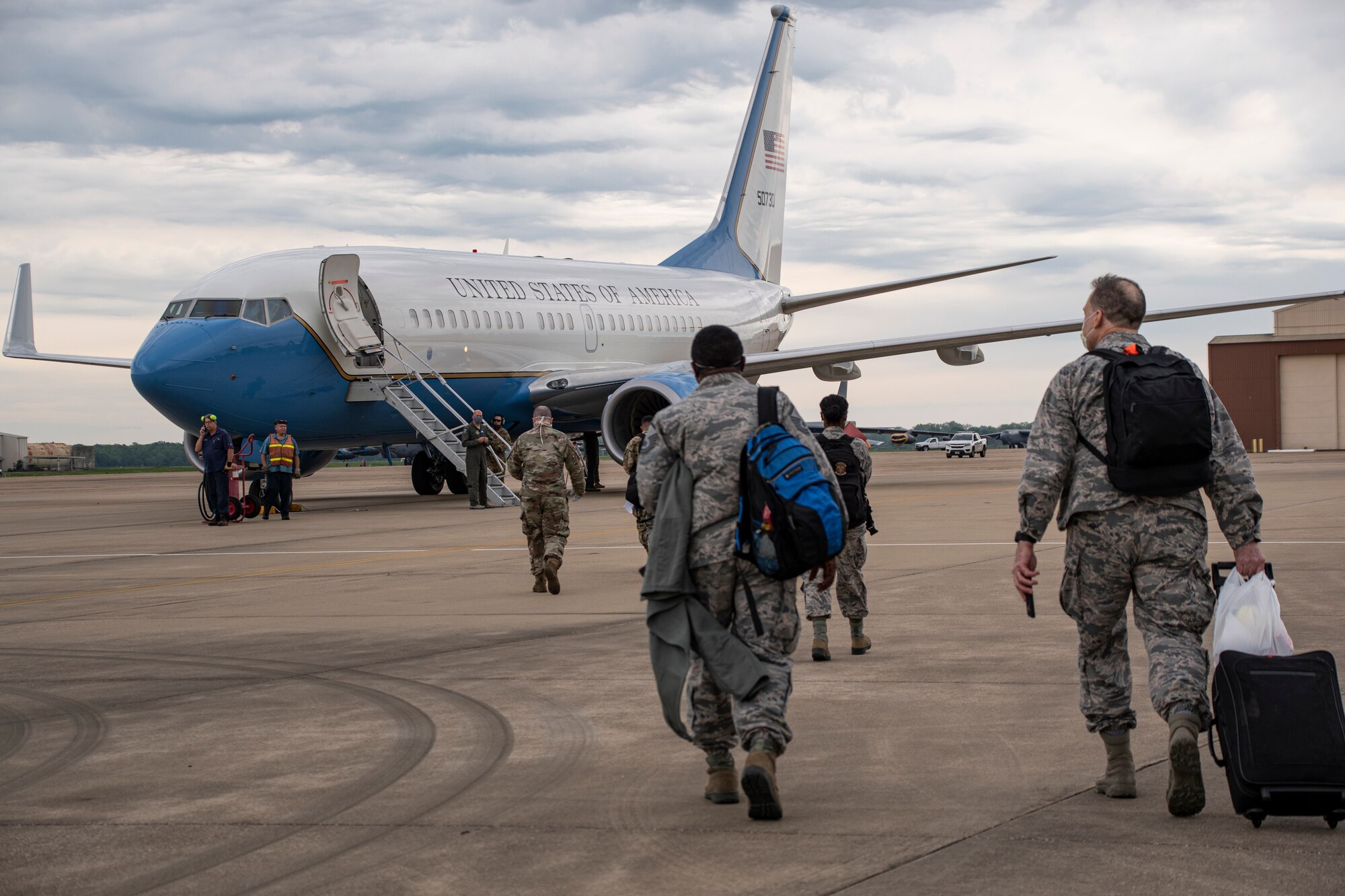 Members board a plane