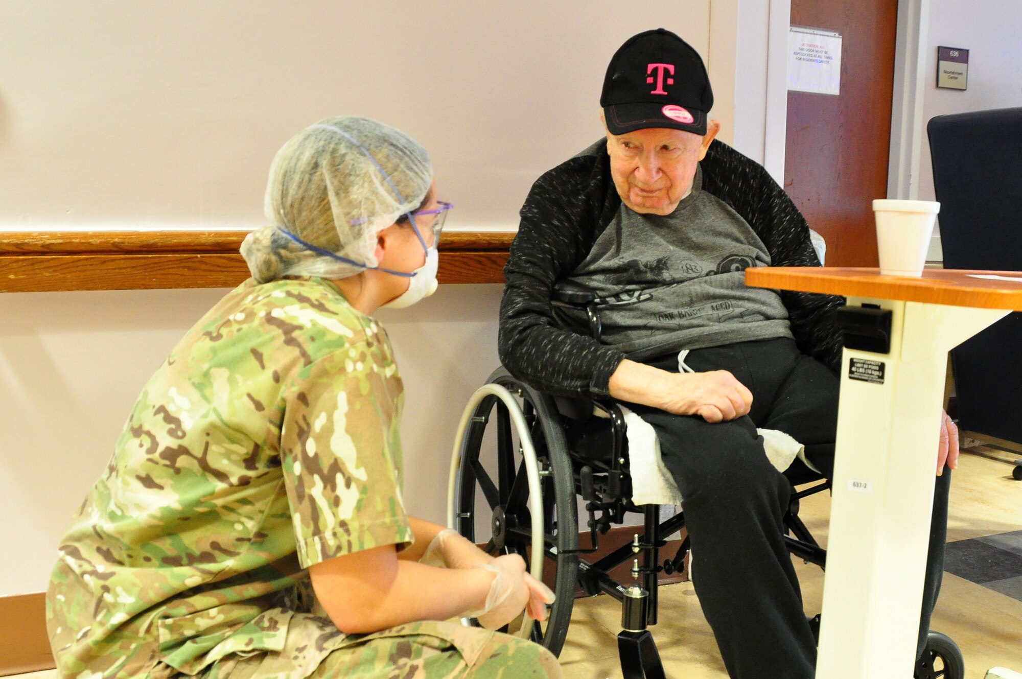 A picture of U.S. Army Spc. Olivia Cordero, a Combat Medic with the 1st Battalion, 114th Infantry Regiment, New Jersey Army National Guard, checking on a resident.