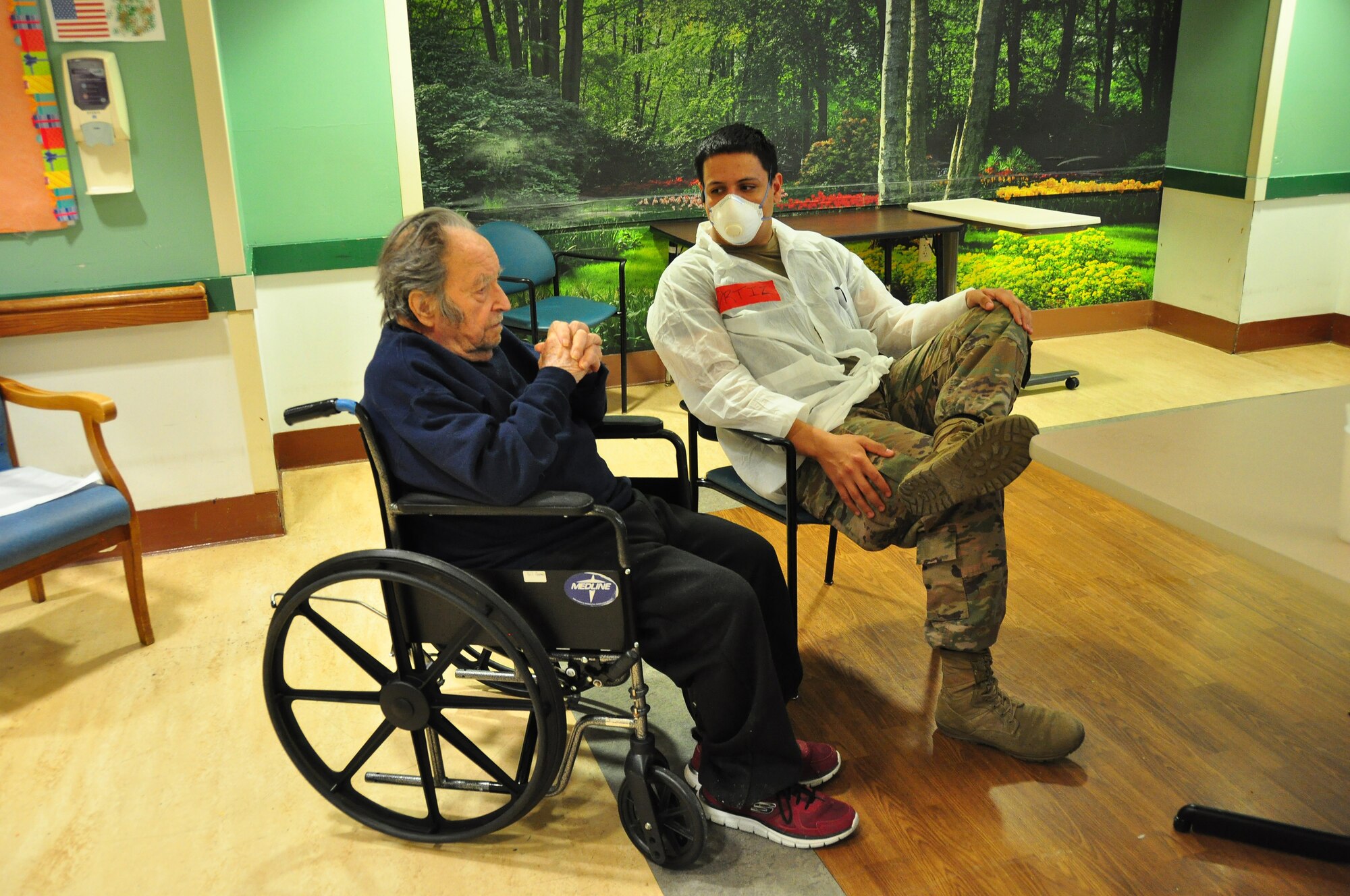 A picture of U.S. Army Spc. Daniel Ortiz, a Combat Medic with the 1st Battalion, 114th Infantry Regiment, New Jersey Army National Guard, spending time with a resident