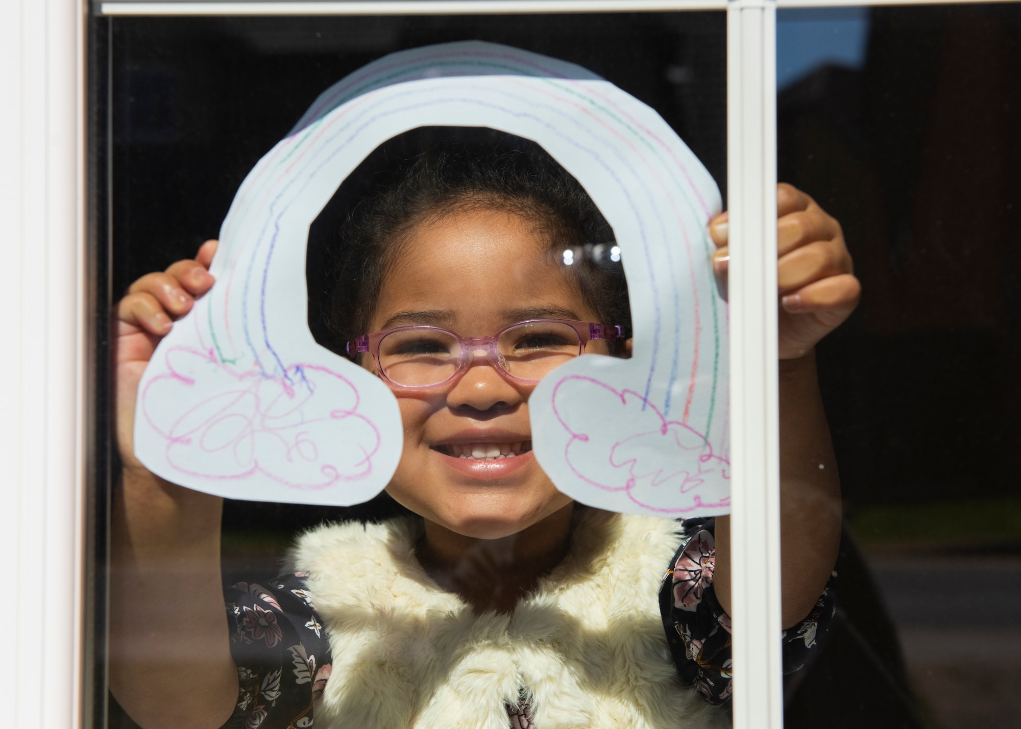 A child of a U.S. Air Force Airman displays rainbow artwork in their window in Liberty Village at Royal Air Force Lakenheath, England, April 22, 2020. Rainbows often appear when the sun comes out after a rainstorm and are currently being displayed in homes across RAF Lakenheath to serve as a reminder of positivity during the current COVID-19 crisis. (U.S. Air Force photo by Airman 1st Class Jessi Monte)