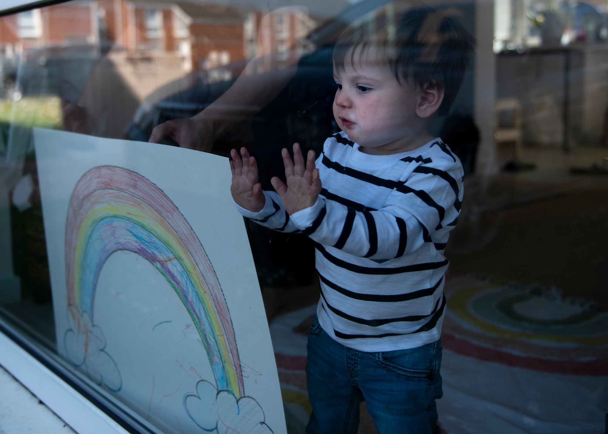A child of a U.S. Air Force Airman displays rainbow artwork in their window in Liberty Village at Royal Air Force Lakenheath, England, April 22, 2020. The rainbow is a symbol of positivity and solidarity among the community during the current COVID-19 crisis. (U.S. Air Force photo by Airman 1st Class Jessi Monte)