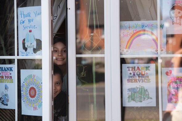 Children of a U.S. Air Force Airman display a rainbow and other artwork in their windows in Liberty Village at Royal Air Force Lakenheath, England, April 22, 2020. The rainbow is a symbol of positivity and is often combined with a message of support for medical professionals serving on the front lines during the current COVID-19 crisis. (U.S. Air Force photo by Airman 1st Class Jessi Monte)