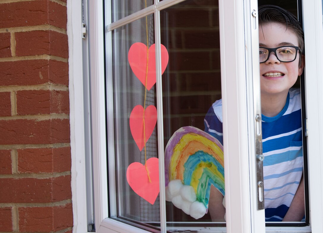 A child of a U.S. Air Force Airman displays a rainbow and other artwork in their window in Liberty Village at Royal Air Force Lakenheath, England, April 22, 2020. Rainbows often appear when the sun comes out after a rainstorm and are currently being displayed in homes across RAF Lakenheath to serve as a reminder of positivity during the current COVID-19 crisis. (U.S. Air Force photo by Airman 1st Class Jessi Monte)