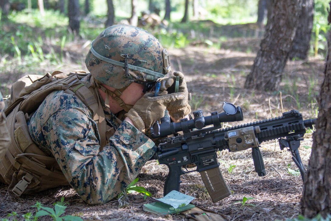 A U.S. Marine with the Special Purpose Marine Air-Ground Task Force-Crisis Response-Africa 20.1, Marine Forces Europe and Africa, looks through a lensatic compass during offensive operations at Morón Air Base, Spain, April 14, 2020. Marines are participating in a three-week block training schedule to continue to train and practice mission essential skills which provides valuable experience and enable their leadership skills. SPMAGTF-CR-AF is deployed to conduct crisis-response and theater-security operations in Africa and promote regional stability by conducting military-to-military training exercises throughout Europe and Africa. (U.S. Marine Corps photo by Cpl. Kenny Gomez)