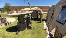 U.S. Army National Guard Soldiers with the 228th Theater Tactical Signal Brigade and Joint Force Headquarters set up signal equipment at McEntire Joint National Guard Base, South Carolina, April 17, 2020 to showcase the network capabilities available to support potential telemedicine, or virtual medical care, in support of COVID-19 response efforts in the state.  The equipment can be used as a primary or secondary network capability for health care providers for the medical databases that enable the medical community to assess and treat patients remotely, if needed.  The South Carolina National Guard remains ready to support the counties, local and state agencies, and first responders with requested resources for as long as needed in support of COVID-19 response efforts in the state. (Courtesy photo)