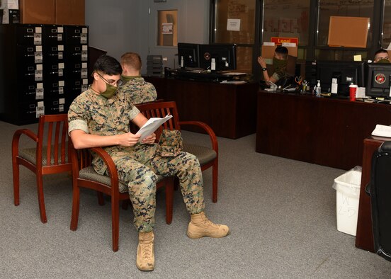 U.S. Marine Corps Lance Corporal Sebastian Ramirez, Cryptologic Linguist student, waits his turn to discuss his orders in the MCD Personnel Administrative Office on Goodfellow Air Force Base, Texas, April 22, 2020. Ramirez practiced proper Center of Disease Control measures by social distancing and wearing a mask. (U.S.Air Force photo by Airman 1st Class Abbey Rieves)