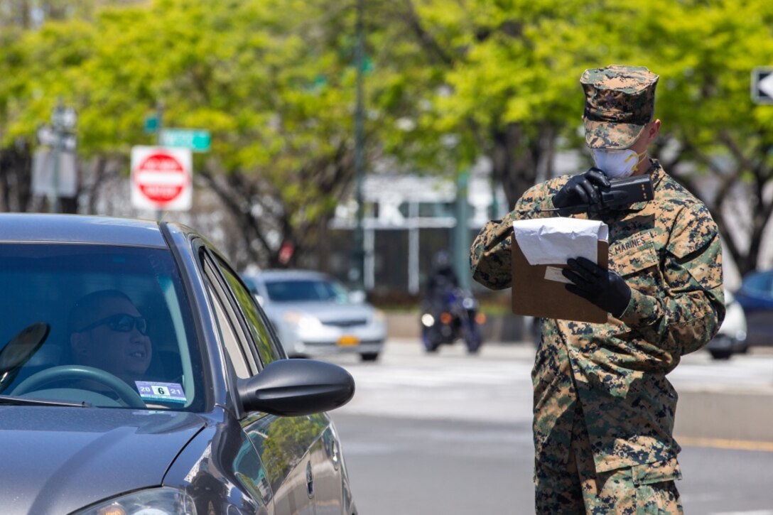 Lance Cpl. Wayne Parsons, a rifleman with Lima Company, 3rd Battalion, 2nd Marines, Task Force New York, radios in while providing security for the USNS Comfort (T-AH 20) during COVID-19 relief efforts in New York City, April 19, 2020.