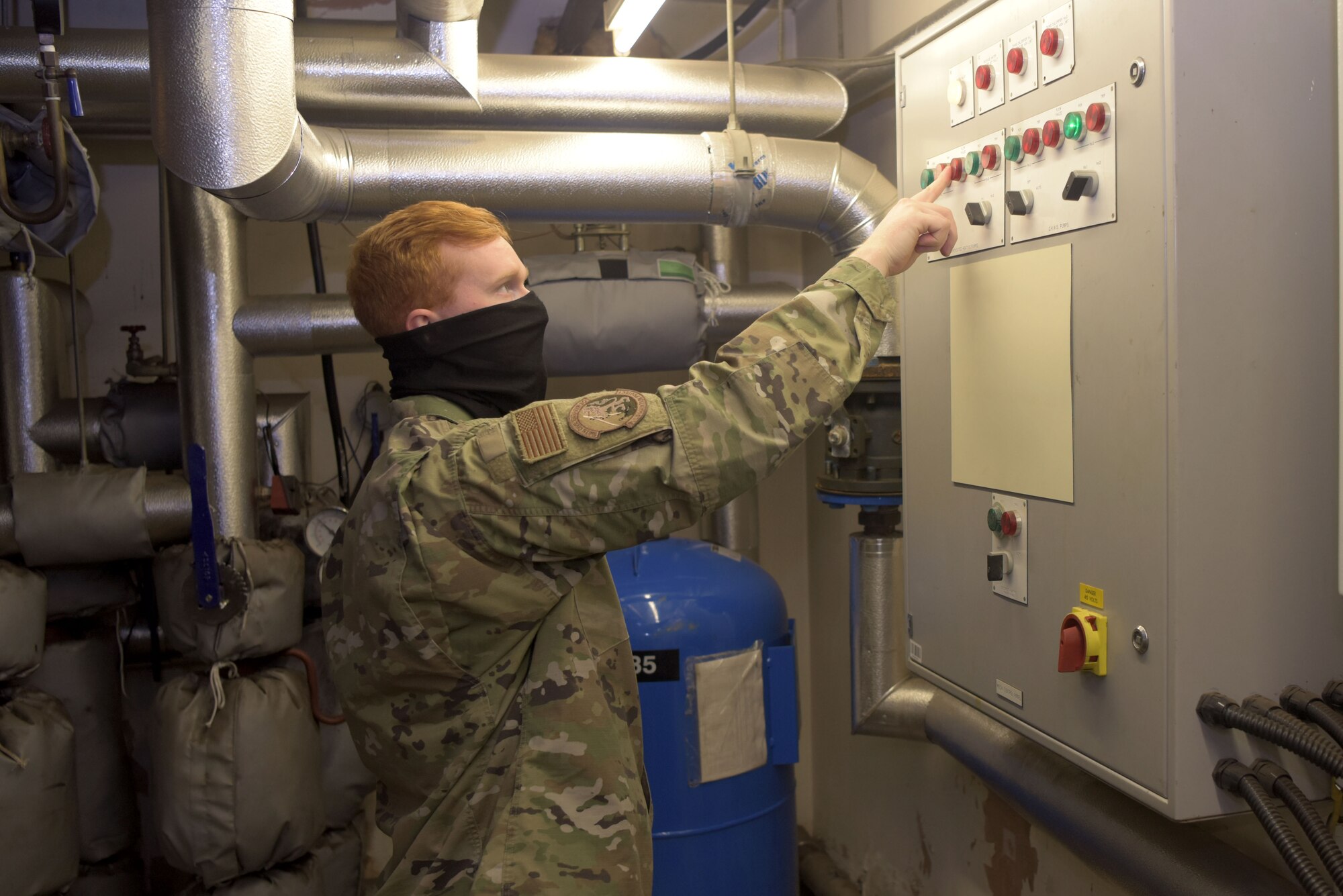 Staff Sgt. Matthew Little, 100th Civil Engineer Squadron base infrastructure assessment team, checks a breaker in the boiler room of the contingency building at RAF Mildenhall, April 22, 2020. The building underwent an overall quality assurance check, performed by the 100th CES prior to receiving transient Airmen. (U.S. Air Force photo by Senior Airman Benjamin Cooper)
