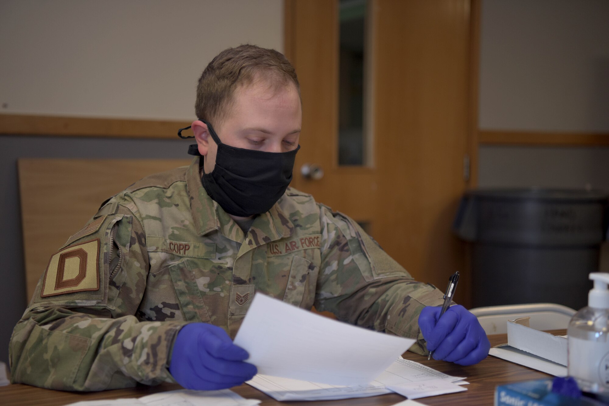 Staff Sgt. Adam Copp, 100th Force Support Squadron sports director, makes a note while checking inventory at RAF Mildenhall, April 22, 2020. A database was created for the contingency building, by the 100th FSS, in order to track availability in real time. (U.S. Air Force photo by Senior Airman Benjamin Cooper)