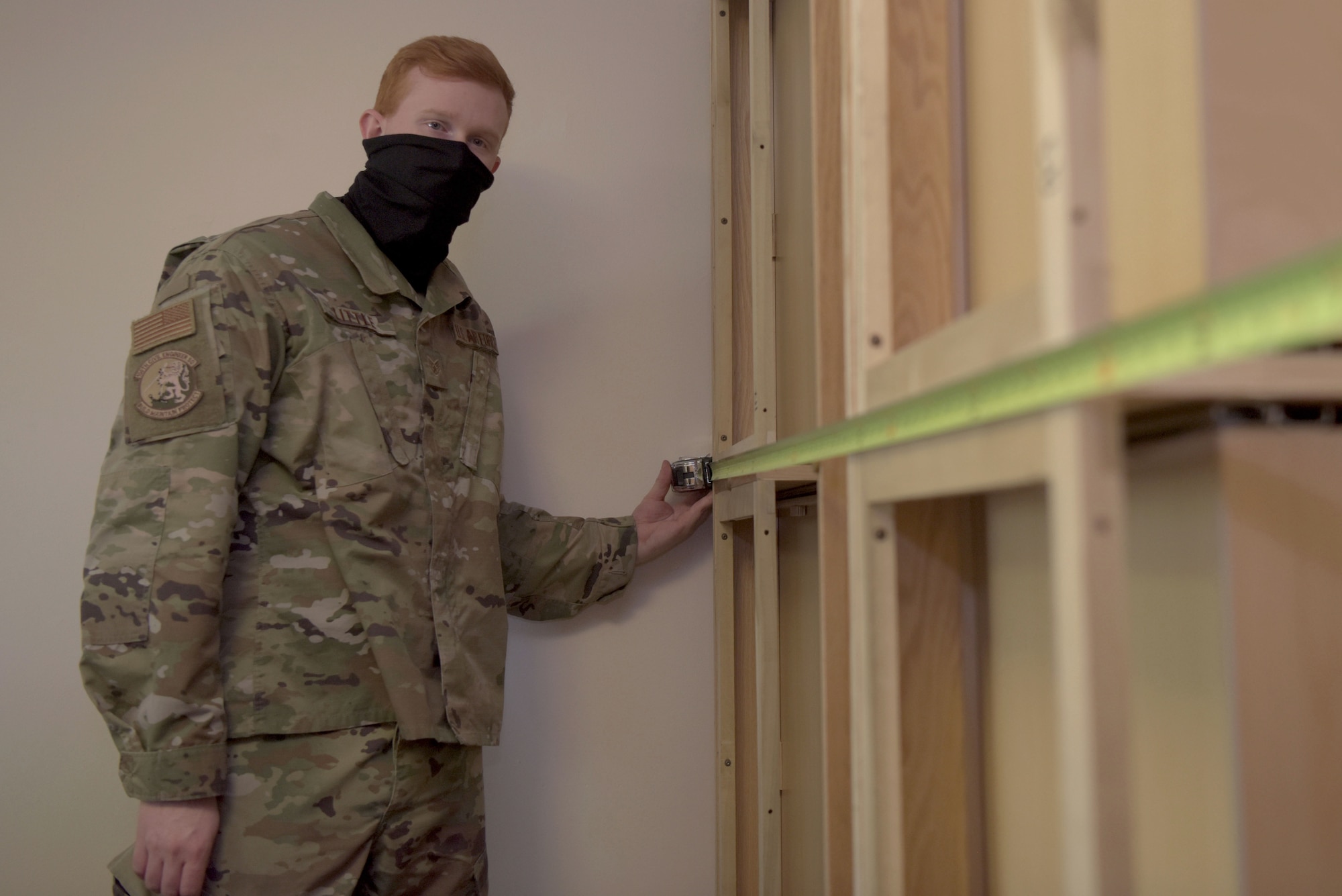 Staff Sgt. Matthew Little, 100th Civil Engineer Squadron base infrastructure assessment team, measures furniture to be remove from the contingency building at RAF Mildenhall, April 22, 2020. Airmen from the 100th CES furnished the building with all the required items to house transient Airmen. (U.S. Air Force photo by Senior Airman Benjamin Cooper)