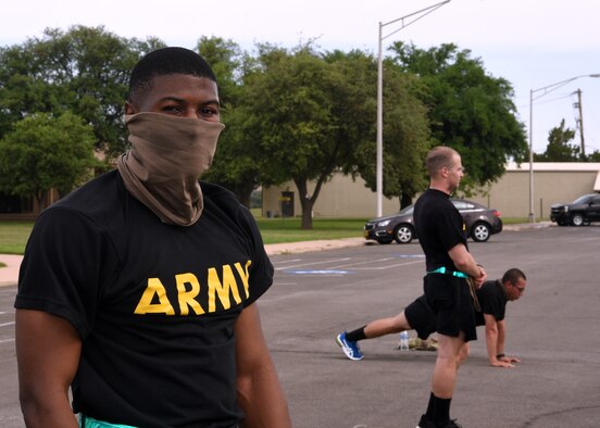 U.S. Army Specialist Bryan Jeanty, 344th Military Intelligence Battalion Company C. student, catches his breath during a mid-morning physical training session on Goodfellow Air Force Base, Texas, April 22, 2020. Army PT sessions complied with social distancing and wearing masks amidst the COVID-19 pandemic. (U.S. Air Force photo by Airman 1st Class Abbey Rieves)