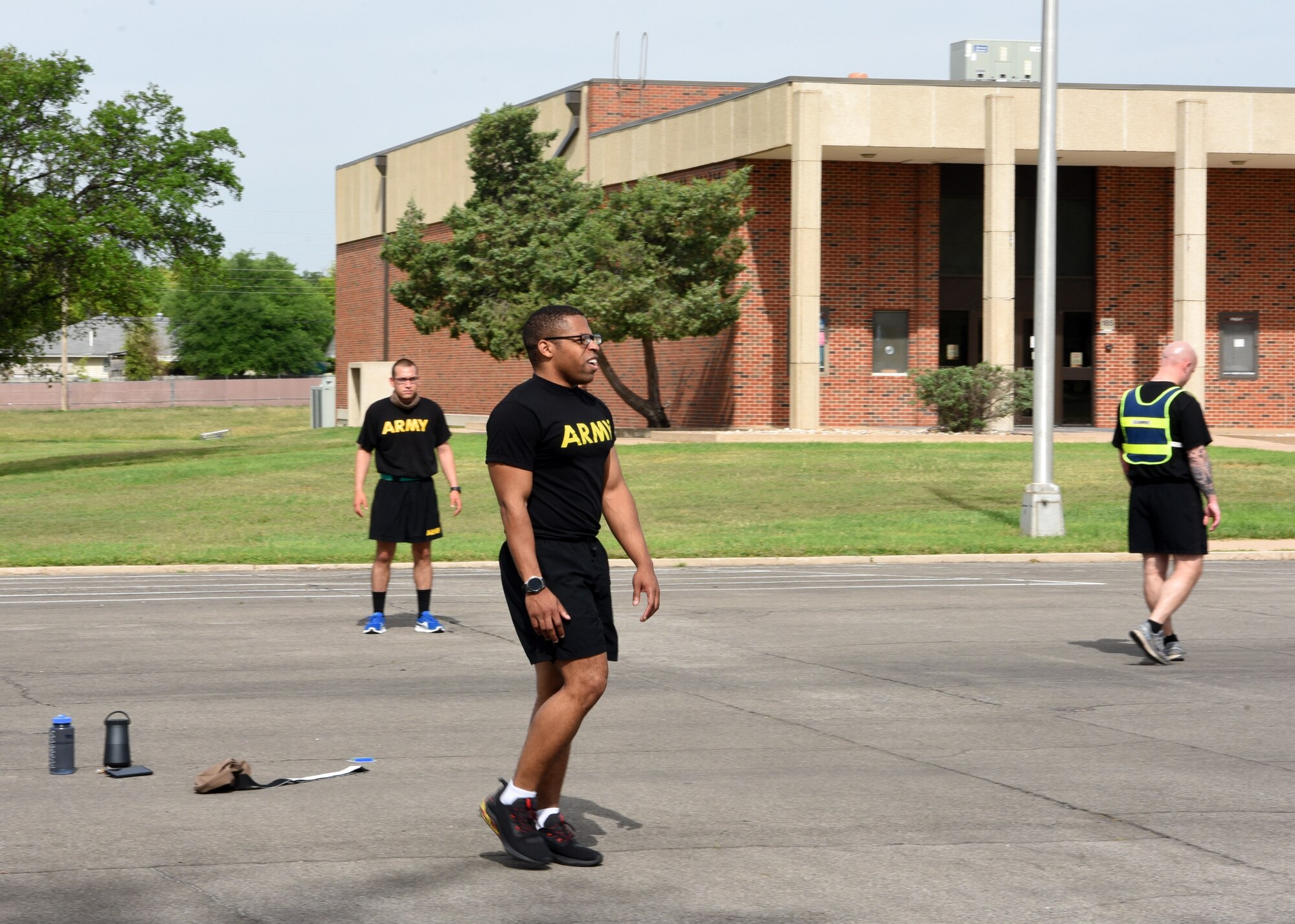 U.S. Army Staff Sgt. Thomas Sarter, 344th Military Intelligence Battalion Company C. instructor, leads his students during a mid-morning physical training session on Goodfellow Air Force Base, Texas, April 22, 2020. Sarter led PT during traditional classroom hours, because standard operating times were remanaged during the COVID-19 pandemic. (U.S. Air Force photo by Airman 1st Class Abbey Rieves)