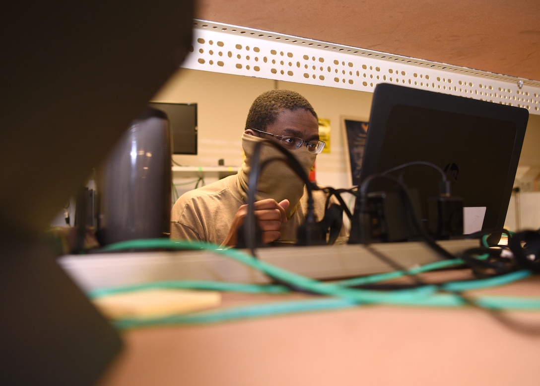 U.S. Air Force Senior Airman Lydell Mitchel, 17 Communications Squadron client systems technician, fixes a laptop while wearing a mask and keeps a social distance in the image lab on Goodfellow Air Force Base, Texas, April 22, 2020. The 17th CS kept the mission vibrant by preparing essential personnel with devices and enabling members to work from home during this pandemic.(U.S. Air Force Photo by Airman 1st Class Abbey Rieves)