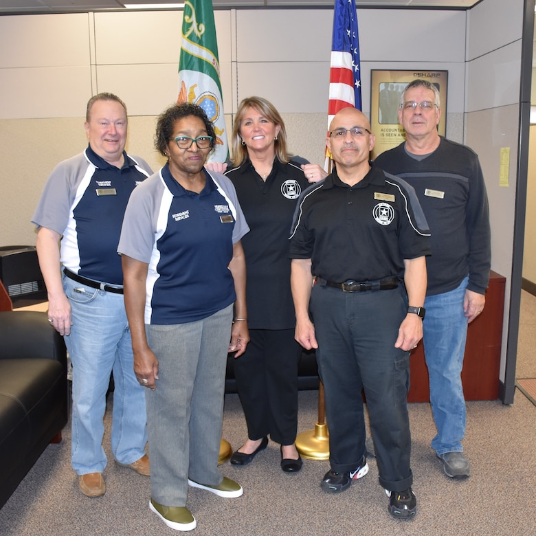 Photo of Arleen Coates (center) and her team (from left) Jerry Nappi, Shirley Thompson, Wilfredo Ruiz, and John Dennish