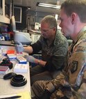 U.S. Army Reserve Sgt. 1st Class Blayne Peterson, right, a combat medic with the 773rd Civil Support Team, 7th Mission Support Command from Kaiserslautern, Germany, and Maj. Dmitry Pervistky, a bio-chemist with the 773rd CST, conduct testing for COVID-19 in a mobile lab at Drawsko Pomorskie Training Area, Poland, April 14, 2020. A team of four Soldiers from the 773rd CST is charged with testing incoming personnel to ensure they are not introducing COVID to a relatively COVID-free environment.

(U.S. Army Reserve photo by 1st Sgt. Domenic Barbeiro/Released)