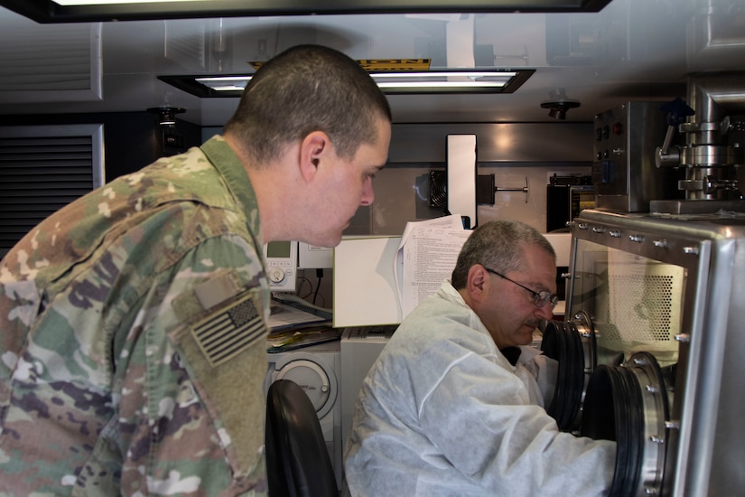 U.S. Army Reserve Maj. Dmitry Pervistky, right, a bio-chemist with the 773rd Civil Support Team, 7th Mission Support Command, from Kaiserslautern, Germany, explains Novel Coronavirus lab procedures to Sgt. Kyle Reitnauer, lab technician with 2nd Armored Brigade Combat Team, 3rd Infantry Division, at Drawsko Pomorskie Training Area, Poland, April 17, 2020. A team of four Soldiers from the 773rd CST is charged with testing incoming personnel to ensure they are not introducing COVID to a relatively COVID-free environment.

(U.S. Army Reserve photo by Staff Sgt. Chris Jackson/Released)