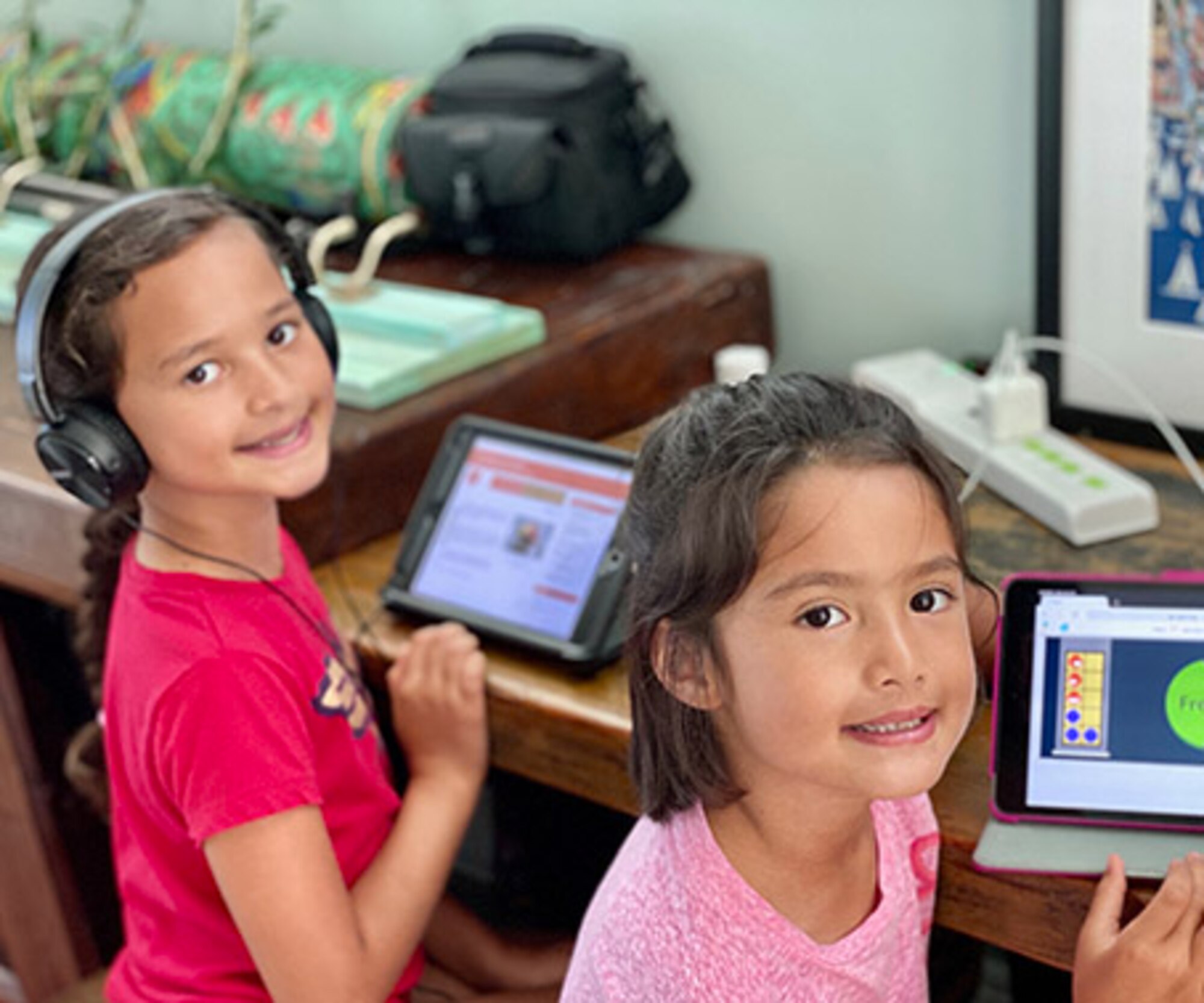 Belen (left) and Paloma (right), daughters of Maj. Sarah Bowles, 325th Logistics Readiness Squadron commander, doing school work from home on tablets. Their school is closed due to the COVID-19 pandemic. (Courtesy Photo)