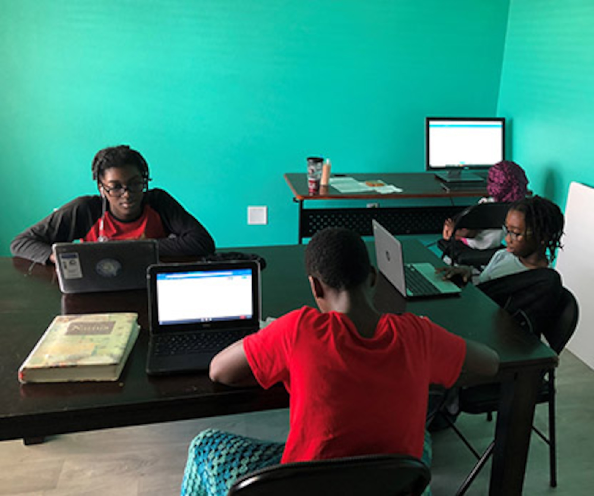 Cameron (left), Deion (center), Sean (right) and Mackenzie (back right), children of Staff Sgt. Samuel Monroe, 325th Comptroller Squadron commander support staff noncommissioned officer in charge, doing school work from home on computers. Their schools are closed due to the COVID-19 pandemic. (Courtesy Photo)