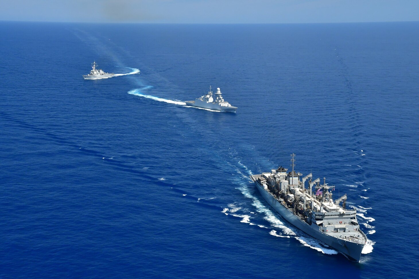 200422-N-NO090-0001 MEDITERRANEAN SEA- The Arleigh Burke-class guided-missile destroyer USS Porter (DDG 78), USNS Supply (T-AOE 6), and ITS Federico Martinengo (F 596) conduct a photo exercise (PHOTOEX) while conducting joint operations to ensure maritime security in the Mediterranean Sea, 22 April. The frequent seamless operations between the Italian and American navies demonstrate strength and professionalism inherent in steady, practiced partnership. U.S. 6th Fleet, headquartered in Naples, Italy, conducts the full spectrum of joint and naval operations, often in concert with allied and interagency partners, in order to advance U.S. national interests and security and stability in Europe and Africa. (Photo courtesy of U.S. Navy)