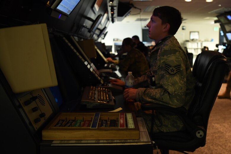 Staff Sgt. Dylan Fivecoate, 14th Operations Support Squadron Air Traffic controller, sits at his desk monitoring aircraft in the Radar Approach Control room April 22, 2020, on Columbus Air Force Base, Miss. The RAPCON, Tower, and Airfield Management sections work closely with base aircraft and coordinate with other base agencies to keep the airfield at a high level of readiness. (U.S. Air Force photo by Airman 1st Class Jake Jacobsen)