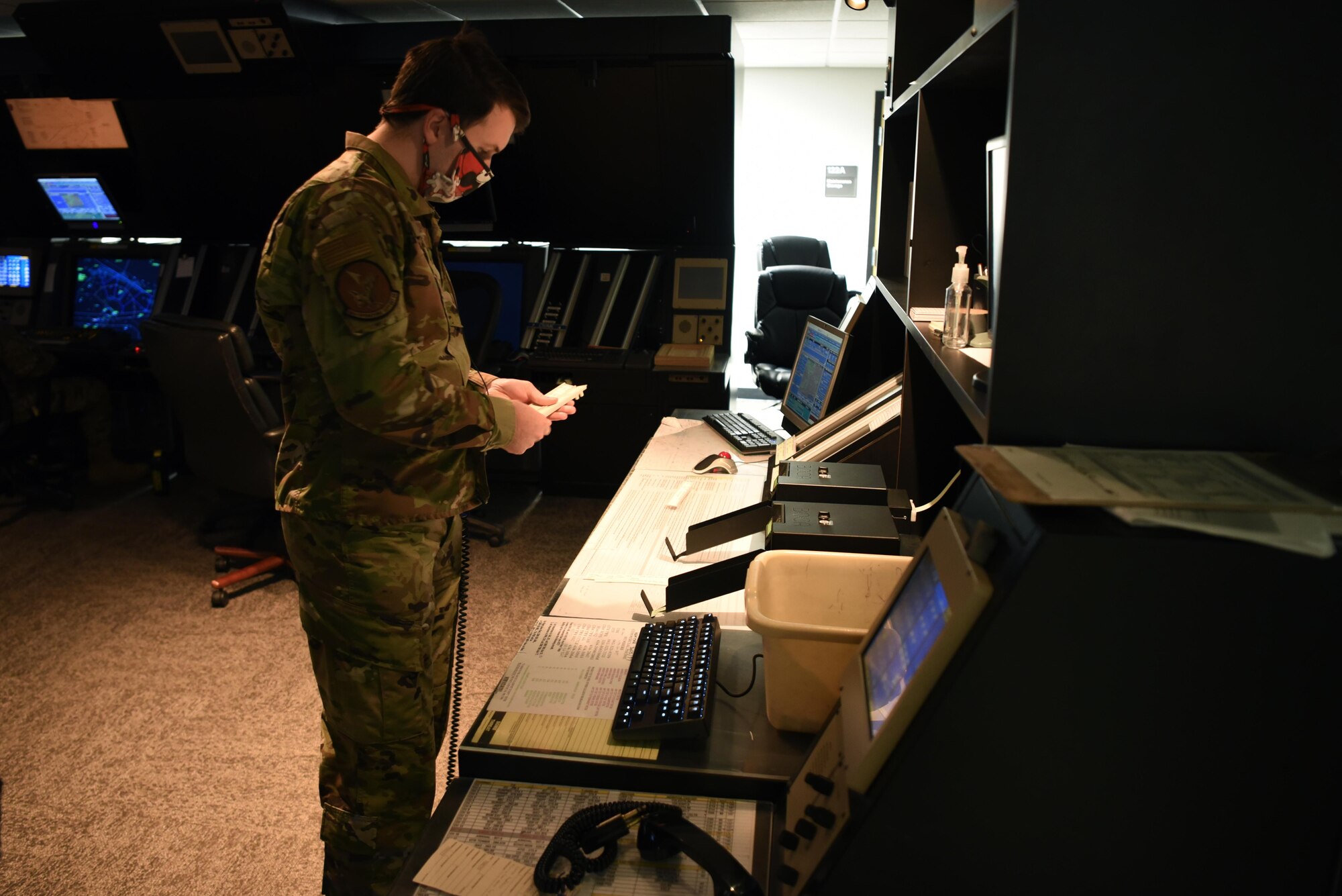 Senior Airman Jonathan Coffee, 14th Operations Support Squadron Air Traffic controller, organizes and keeps track of aircraft in the Radar Approach Control room April 22, 2020, on Columbus Air Force Base, Miss. The Radar Approach Control is responsible for controlling both military and civilian traffic in the Columbus assigned airspace, which serves 13 civilian and two military airfields.  (U.S. Air Force photo by Airman 1st Class Jake Jacobsen)