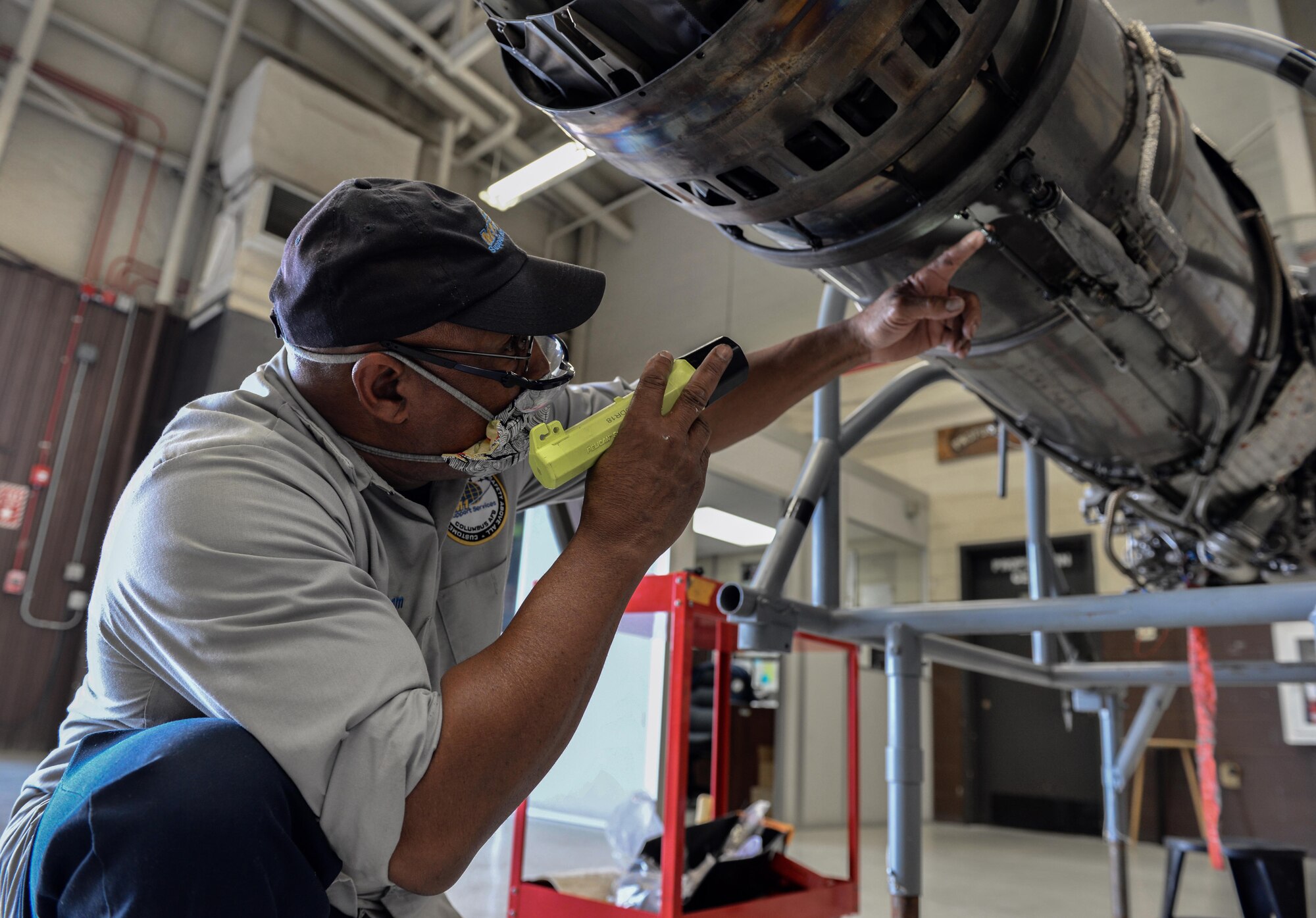 Willy Latham, M1 Support Services propulsion mechanic, inspects a General Electric J85-GE-5 turbojet engine April 17, 2020, at Columbus Air Force Base, Miss. On an aerospace vehicle, the propulsion system creates thrust by accelerating a gas, or "working fluid”. (U.S. Air Force photo by Airman 1st Class Davis Donaldson)